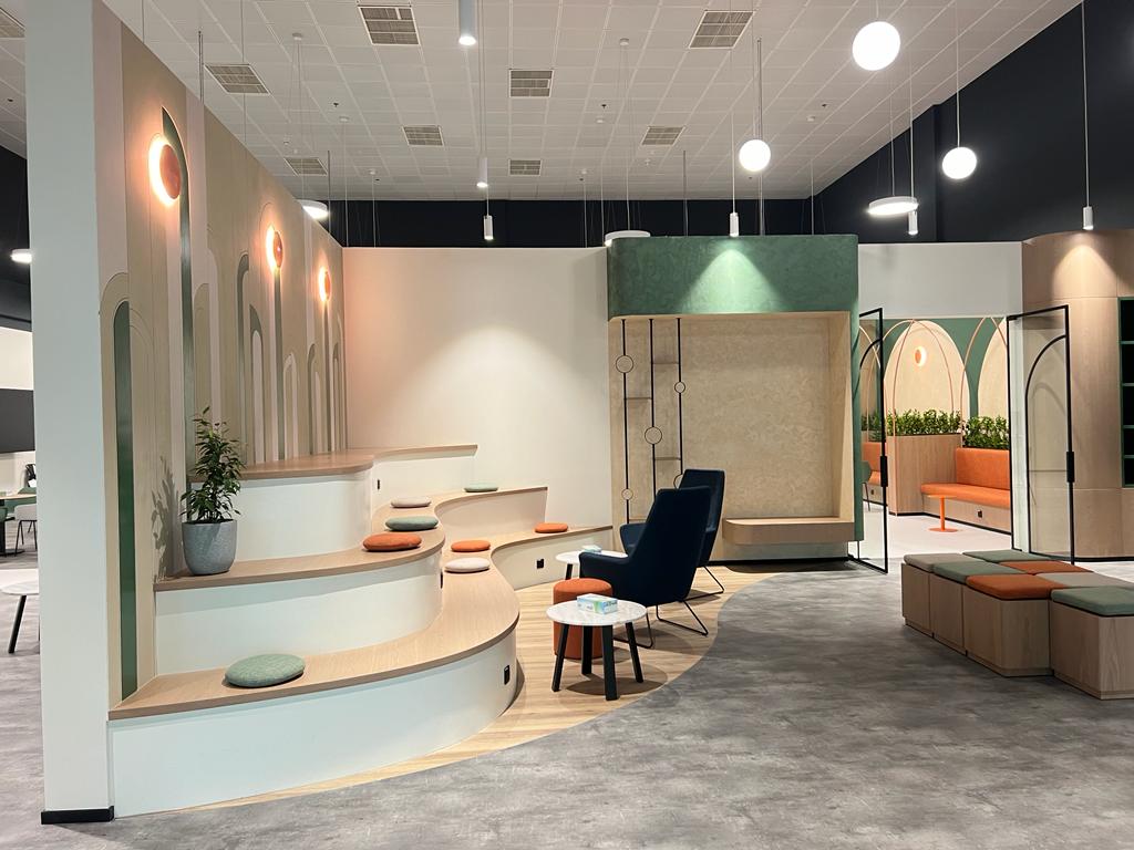 Workspace breakout lounge with tiered seating and collaboration pods